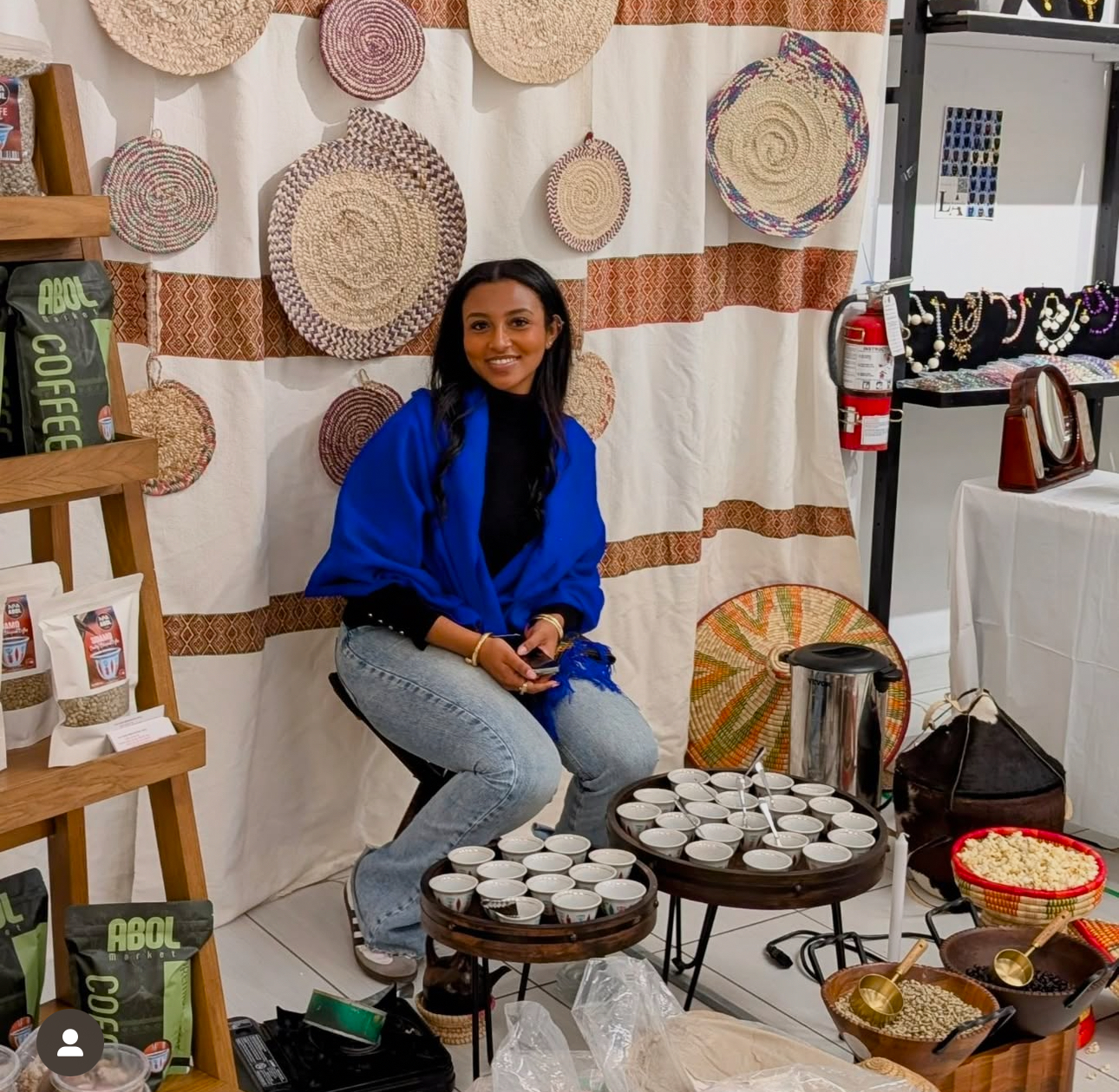 Woman sitting at a booth with food samples